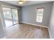 Bedroom with wood-look floors and sliding glass doors to patio at 18300 Troon Ave, Port Charlotte, FL 33948