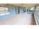 Bright screened porch with tiled floors and view of backyard at 18300 Troon Ave, Port Charlotte, FL 33948
