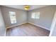 Bright bedroom with wood-look floors and large windows at 18300 Troon Ave, Port Charlotte, FL 33948