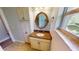 Elegant bathroom featuring granite countertop and a large mirror at 18300 Troon Ave, Port Charlotte, FL 33948