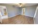 Well-lit bedroom with wood-look floors and access to bathroom at 18300 Troon Ave, Port Charlotte, FL 33948