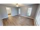Spacious bedroom with wood-look floors and ceiling fan at 18300 Troon Ave, Port Charlotte, FL 33948