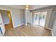 Bright bedroom with wood-look floors and access to patio at 18300 Troon Ave, Port Charlotte, FL 33948