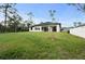 Modern home with covered patio and expansive yard, perfect for outdoor activities and relaxation at 5815 Casanova Ave, North Port, FL 34291