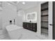 Modern bathroom featuring soaking tub, vanity, and closet at 5815 Casanova Ave, North Port, FL 34291