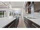 Bright modern kitchen with a large island, white countertops, and pendant lighting overlooking the great room at 5815 Casanova Ave, North Port, FL 34291