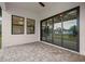 Outdoor patio featuring brick flooring and access through sliding glass doors and windows at 5815 Casanova Ave, North Port, FL 34291