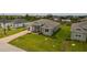 Single-story home with gray exterior, paved driveway, and landscaped lawn at 15512 Greenwood Ave, Port Charlotte, FL 33981
