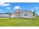 New construction home with a two-car garage and well manicured lawn at 15512 Greenwood Ave, Port Charlotte, FL 33981