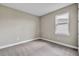 Well-lit bedroom with neutral walls and carpet at 15512 Greenwood Ave, Port Charlotte, FL 33981