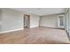 Spacious living area with wood-look tile floors and access to other rooms at 15512 Greenwood Ave, Port Charlotte, FL 33981