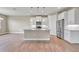 Modern kitchen with white cabinets, granite island, and stainless steel appliances at 15512 Greenwood Ave, Port Charlotte, FL 33981