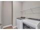 Laundry room with washer, dryer, and overhead shelving at 15512 Greenwood Ave, Port Charlotte, FL 33981