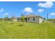 Spacious backyard with lush grass and young trees at 15512 Greenwood Ave, Port Charlotte, FL 33981