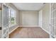 Bright home office features wood-look tile flooring, large window, and French doors at 15512 Greenwood Ave, Port Charlotte, FL 33981
