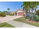 Stunning curb appeal with lush landscaping and driveway at 1081 Coronado Dr, Punta Gorda, FL 33950