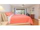 Bright bedroom with coral bedding and water view at 1081 Coronado Dr, Punta Gorda, FL 33950