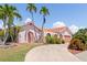 Beautiful home exterior with palm trees and driveway at 1081 Coronado Dr, Punta Gorda, FL 33950