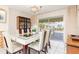 Bright dining room with a glass-top table, six chairs, and view of the pool at 1081 Coronado Dr, Punta Gorda, FL 33950