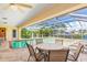 Inviting pool area with covered patio, seating, and lush landscaping at 1081 Coronado Dr, Punta Gorda, FL 33950