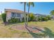 Landscaped backyard with mature trees and shrubs at 1081 Coronado Dr, Punta Gorda, FL 33950