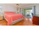 Spacious bedroom with coral bedding and pool view at 1081 Coronado Dr, Punta Gorda, FL 33950