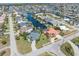 Aerial showcasing canal-front home, neighborhood, and boats at 1081 Coronado Dr, Punta Gorda, FL 33950