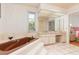 Bathroom with a brown jacuzzi tub and double vanity at 1081 Coronado Dr, Punta Gorda, FL 33950