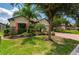 Well-maintained house with palm trees and a brick driveway at 4093 River Bank Way, Punta Gorda, FL 33980