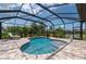 Relaxing kidney-shaped pool with a screened enclosure and patio at 4093 River Bank Way, Punta Gorda, FL 33980