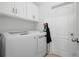 Laundry room with washer, dryer, and storage cabinets at 4093 River Bank Way, Punta Gorda, FL 33980