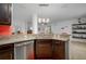 Kitchen features a curved granite countertop island and stainless steel dishwasher at 4093 River Bank Way, Punta Gorda, FL 33980