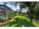 Landscaped backyard with lush greenery and a large tree at 4093 River Bank Way, Punta Gorda, FL 33980