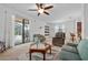 Bright living room with comfortable seating, a coffee table, and sliding glass doors leading to a patio at 4093 River Bank Way, Punta Gorda, FL 33980