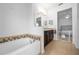 Clean bathroom with a bathtub and double vanity at 4093 River Bank Way, Punta Gorda, FL 33980