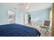 Bedroom featuring blue walls, tiled flooring, ceiling fan, and access to an adjacent room at 7106 Parnell Ter, Englewood, FL 34224