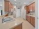 Well-equipped kitchen with light wood cabinets and a double sink at 24449 Manchester Trl, Punta Gorda, FL 33980
