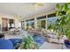 Spacious sunroom with ample seating, large windows, and plants at 24449 Manchester Trl, Punta Gorda, FL 33980