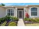 House exterior featuring a screened door and well-maintained landscaping at 24449 Manchester Trl, Punta Gorda, FL 33980