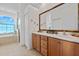 Double vanity bathroom with a large mirror and a soaking tub at 24449 Manchester Trl, Punta Gorda, FL 33980