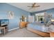 Relaxing bedroom featuring light wood furniture and access to a patio at 24449 Manchester Trl, Punta Gorda, FL 33980