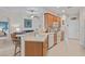 Open kitchen with a breakfast bar, light cabinets, and white appliances at 24449 Manchester Trl, Punta Gorda, FL 33980