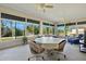 Relaxing sunroom with wicker furniture, a table, and scenic views at 24449 Manchester Trl, Punta Gorda, FL 33980