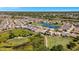Aerial view of community with houses, golf course, lake, and lush landscaping at 24449 Manchester Trl, Punta Gorda, FL 33980