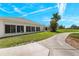 Home's exterior showcases a side view, lush landscaping, and a golf course at 24449 Manchester Trl, Punta Gorda, FL 33980