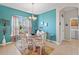 Charming dining room with teal walls and floral chairs at 24449 Manchester Trl, Punta Gorda, FL 33980