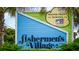 Sign for Fisherman's Village, advertising waterfront dining at 97 Vivante Blvd # 404, Punta Gorda, FL 33950