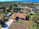 Sprawling aerial view of a single-story home with a detached garage and a lush green backyard at 2721 Shady Ave, North Port, FL 34286