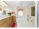 Bathroom featuring a bathtub, double vanity, and large mirror at 16446 Belo Ct, Punta Gorda, FL 33955