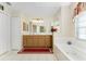 Elegant bathroom with double sinks and a soaking tub at 16446 Belo Ct, Punta Gorda, FL 33955
